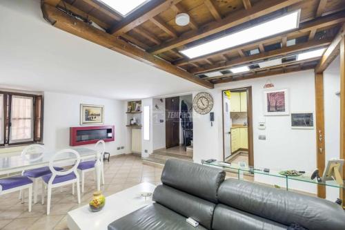 a living room with a couch and a table at Loft Piazza Cavour Vercelli in Vercelli