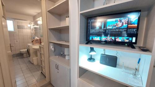 a bathroom with a flat screen tv on a wall at Belva Blue Naxos Stylish, Naxos Town, near Beach in Naxos Chora