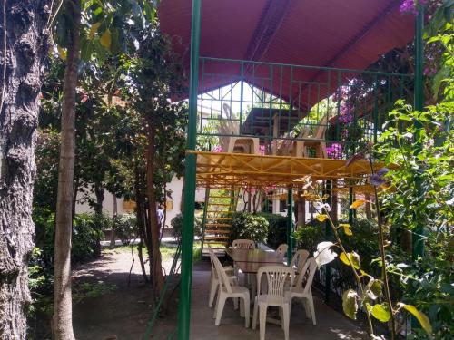 een patio met een tafel en stoelen onder een luifel bij Kibo hotel restaurant in Ayacucho
