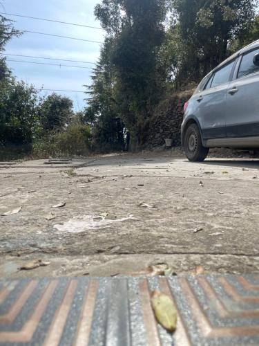 a car parked on the side of a road at Maayaa Ridge House in Kanatal