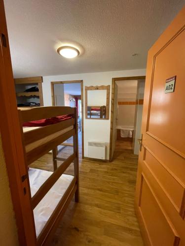 a room with two bunk beds and a hallway at Droseras A02 - Chamrousse 1700 - Les Villages du Bachat in Chamrousse