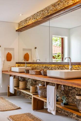 a bathroom with two sinks and a mirror at Vila Panhard - Aldeia Jericoacoara Group in Jericoacoara