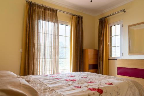 a bedroom with a bed and a large window at The Mountain View, By OP in São Vicente
