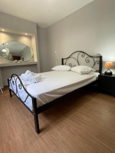 a bedroom with a large bed with a large mirror at Spyros Apartment in Paleo Tsifliki