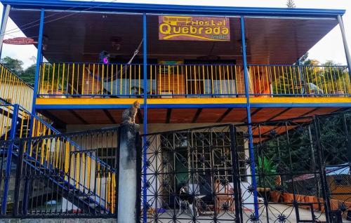 a cat is sitting in a cage in a building at Hostal Quebrada Verde in El Colegio