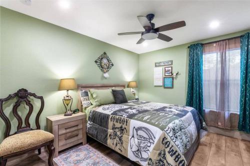 a bedroom with a bed and a ceiling fan at Stockyards 5 mins!-New!-Sleeps 8. Cowboy Bungalow in Fort Worth