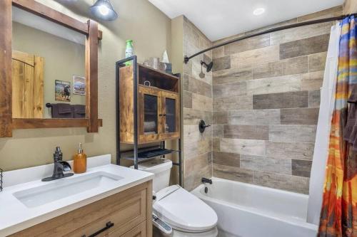 a bathroom with a toilet and a sink and a tub at Stockyards 5 mins!-New!-Sleeps 8. Cowboy Bungalow in Fort Worth