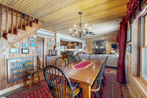 a dining room with a wooden table and chairs at WeSeekANook in Meredith