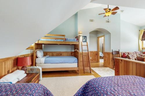 a bedroom with two bunk beds and a staircase at WeSeekANook in Meredith