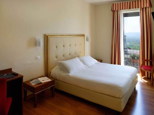 Postel nebo postele na pokoji v ubytování Giotto Hotel & Spa