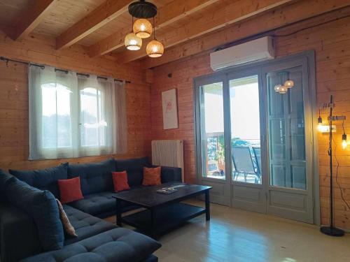 - un salon avec un canapé et une table dans l'établissement ViladeMadeira, Crete, à Amnátos