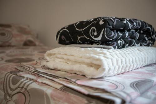 a pile of towels sitting on top of a bed at Bubamara house in Belgrade