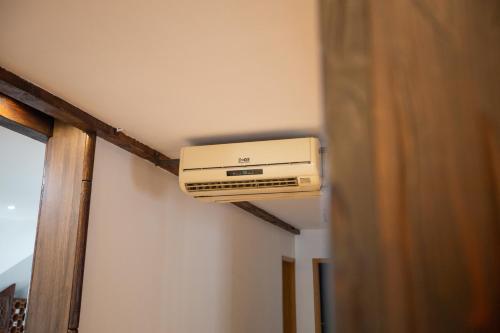 a air conditioner on a ceiling in a room at Bubamara house in Belgrade
