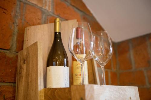 a bottle of wine and two wine glasses at Bubamara house in Belgrade