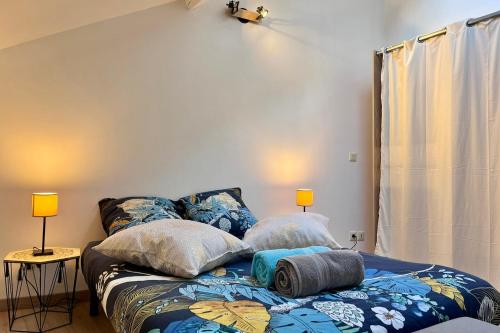 a bed with pillows on it in a room at The Théolier Duplex in Tournon-sur-Rhône