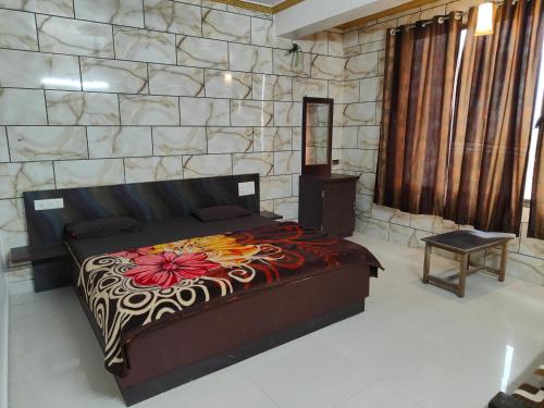 a bedroom with a bed in a room with a stone wall at Hiral valley view residency matheran in Matheran