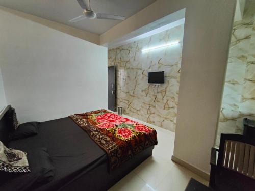 a bedroom with a black bed and a stone wall at Hiral valley view residency matheran in Matheran