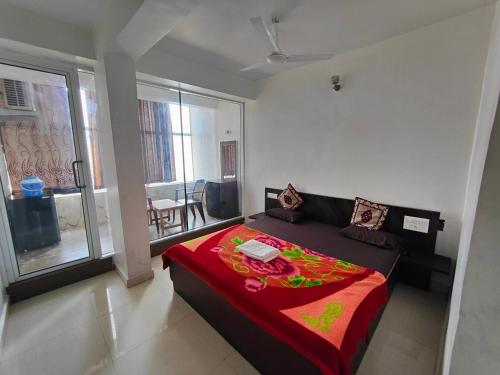 a bedroom with a bed with a red blanket at Hiral valley view residency matheran in Matheran