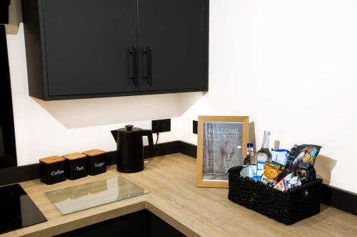 a kitchen counter with a basket of food and a cabinet at Skegness Luxury 2 bedroom apartment , sleeps 6 people in Lincolnshire