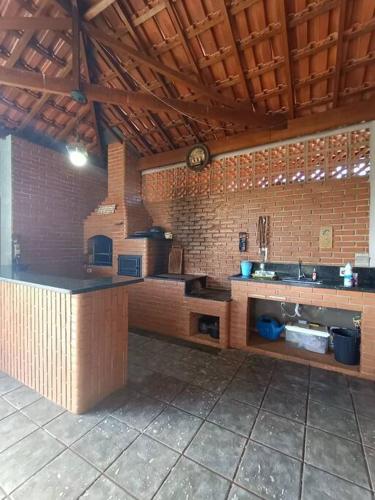 a kitchen with a stove and a counter in a room at Sítio São Sebastião em Monte Sião-MG in Monte Sião