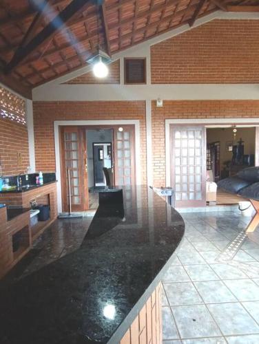 a large living room with a counter in a house at Sítio São Sebastião em Monte Sião-MG in Monte Sião