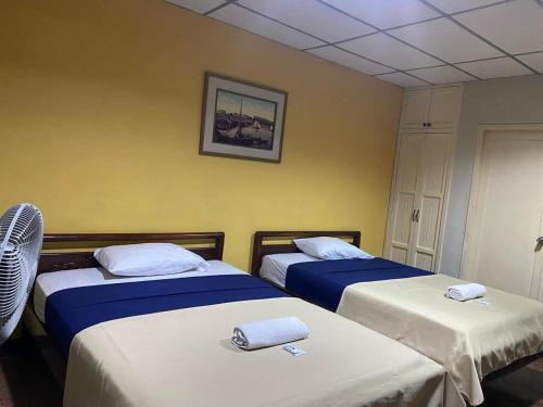 a room with two beds with towels on them at Hotel Andes INN in Guayaquil
