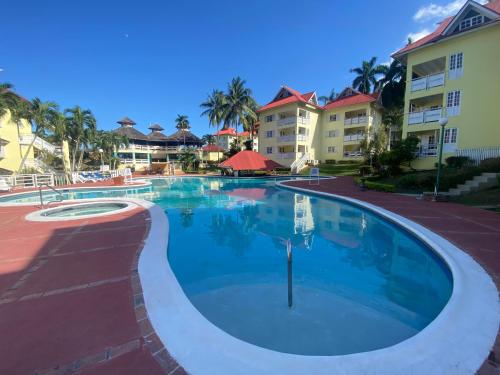 a swimming pool at a resort with buildings at Sunset condos getaway In Ocho Rios in Ocho Rios