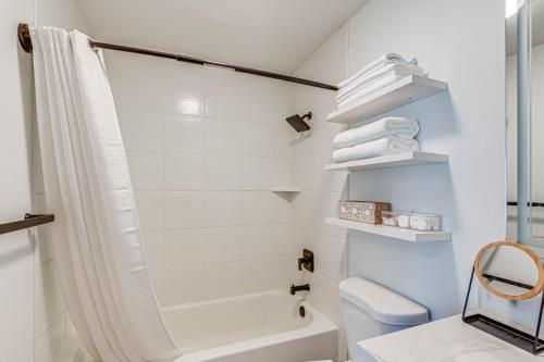 a white bathroom with a shower and a toilet at Pet-Friendly Getaway 15 Mi to Downtown Nashville in Hermitage