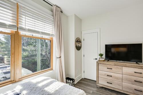 a bedroom with a bed and a television and a window at Dtwn Blowing Rock Condo with Private Hot Tub! in Blowing Rock