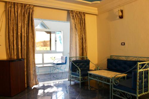 a living room with a couch and chairs and a window at Hotel DONIA in Hammam-Plage
