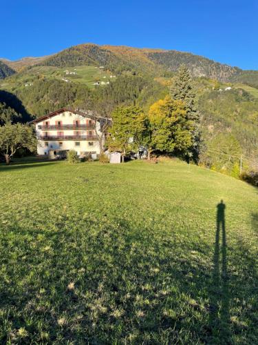 a shadow of a house on a grass field at Plasur - Apartement Bella Vista in Montechiaro