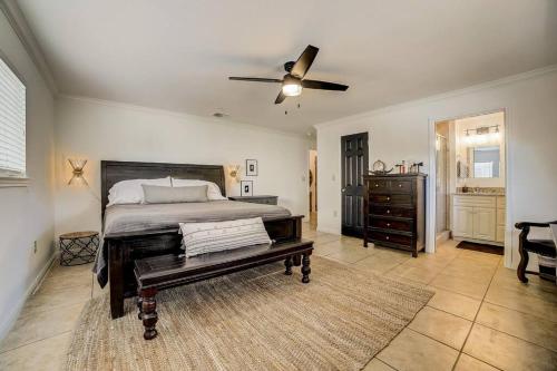 a bedroom with a bed and a ceiling fan at Walk to Schlitterbahn, River Access & Pets OK in New Braunfels