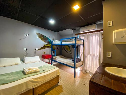 a bedroom with a bunk bed and a sink at Tetris Container Hostel in Foz do Iguaçu