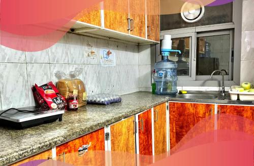 a kitchen with a sink and a counter top at Travelers Friend Capsule 5 min walking Sharaf DG metro station in Dubai