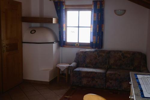 a living room with a couch and a window at Ausser Brugghof in Senales