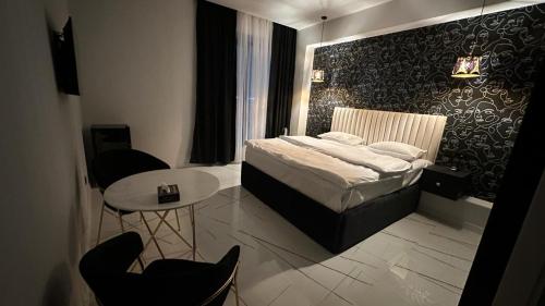 a bedroom with a bed and a table and chairs at Lux Plaza (New Rooms) in Pʼarakʼar