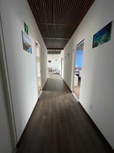 a hallway of a room with white walls and a ceiling at TORRE YAX-CHE URBAN CENTER in Cancún