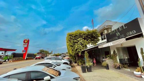 a row of cars parked in front of a store at Hotel Balcon de Oro Curumani in Curumaní