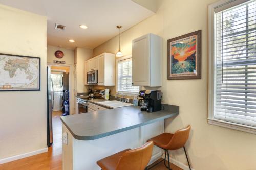 a kitchen with white cabinets and a counter with chairs at Lucky 8 Lake House in Bainbridge with Private Dock in Bainbridge