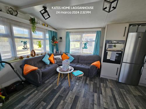 a living room with a couch and a table at Kates Home Lagganhouse Woodland Way 19 in Ballantrae