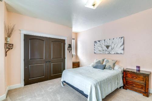 a bedroom with a bed and a brown door at Inviting Wasilla Vacation Rental 6 Mi to Big Lake in Wasilla