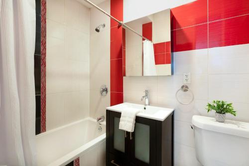 a bathroom with a sink and a toilet and a tub at 24-4 New Private Terrace W D Apt Prime Gramercy in New York