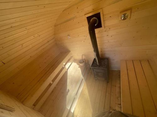 an inside view of a sauna with a wood stove at Casa bunicilor/ Grandparent’s house in Zăbala
