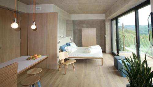Schlafzimmer mit einem Bett, einem Tisch und Stühlen in der Unterkunft Qb Apartments in Montelupo Albese