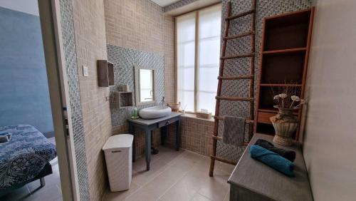a bathroom with a sink and a mirror at Maison bourgeoise de 1881 in Jonzac
