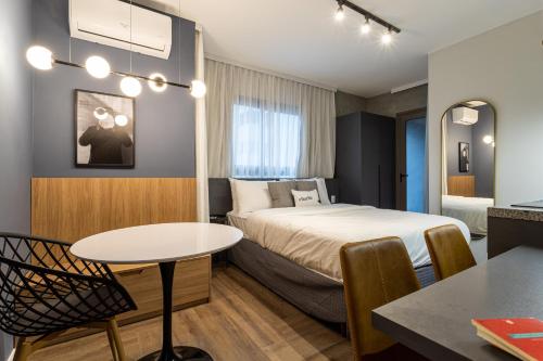 una habitación de hotel con una cama y una mesa en Charlie Nik Perdizes, en São Paulo