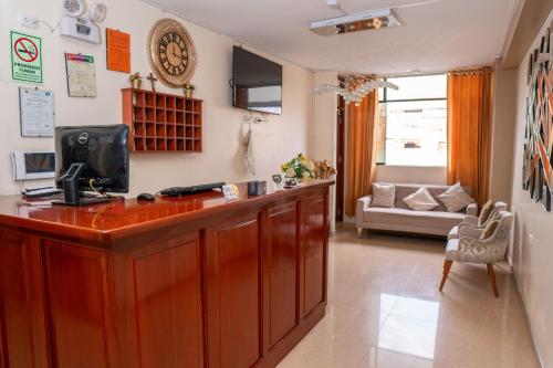 un soggiorno con bancone in legno e TV di Hotel Las Canastas a Jaén