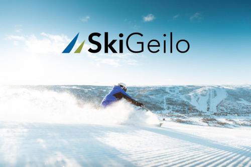 a person is skiing down a snow covered slope at Nice apartment on Geilotunet, Close to city center in Geilo
