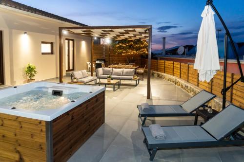 a bathroom with a jacuzzi tub on a patio at Villa Strada Castello in Zakynthos Town