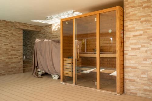 a room with a wooden closet in a brick wall at Casa Lilou - Luxury Oceanview Penthouse in Lagos